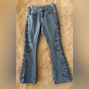 Milk It Cobra Snake Print Flare Leg Rigid Denim With Frey Hem.